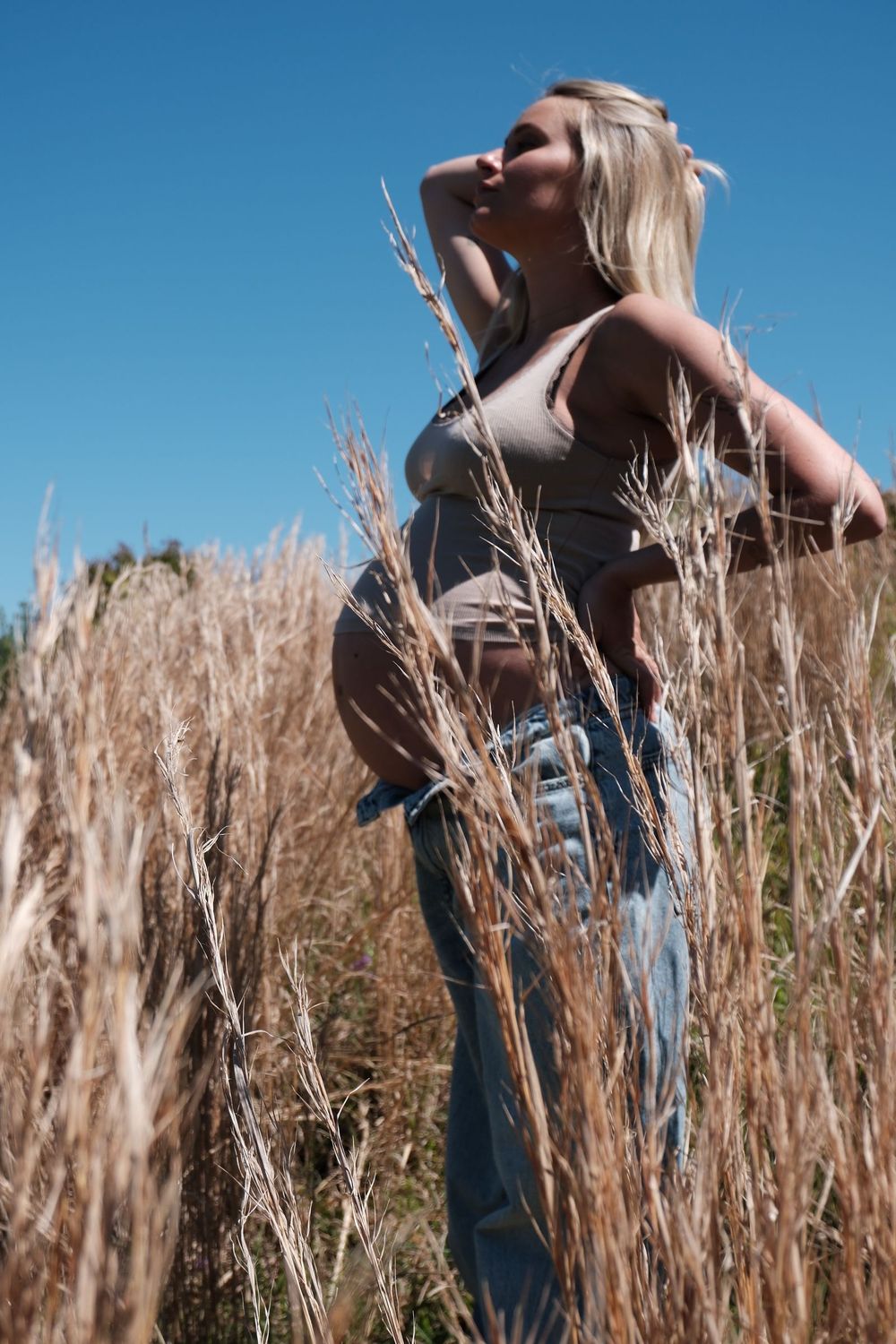 Maternity portrait in dry grass